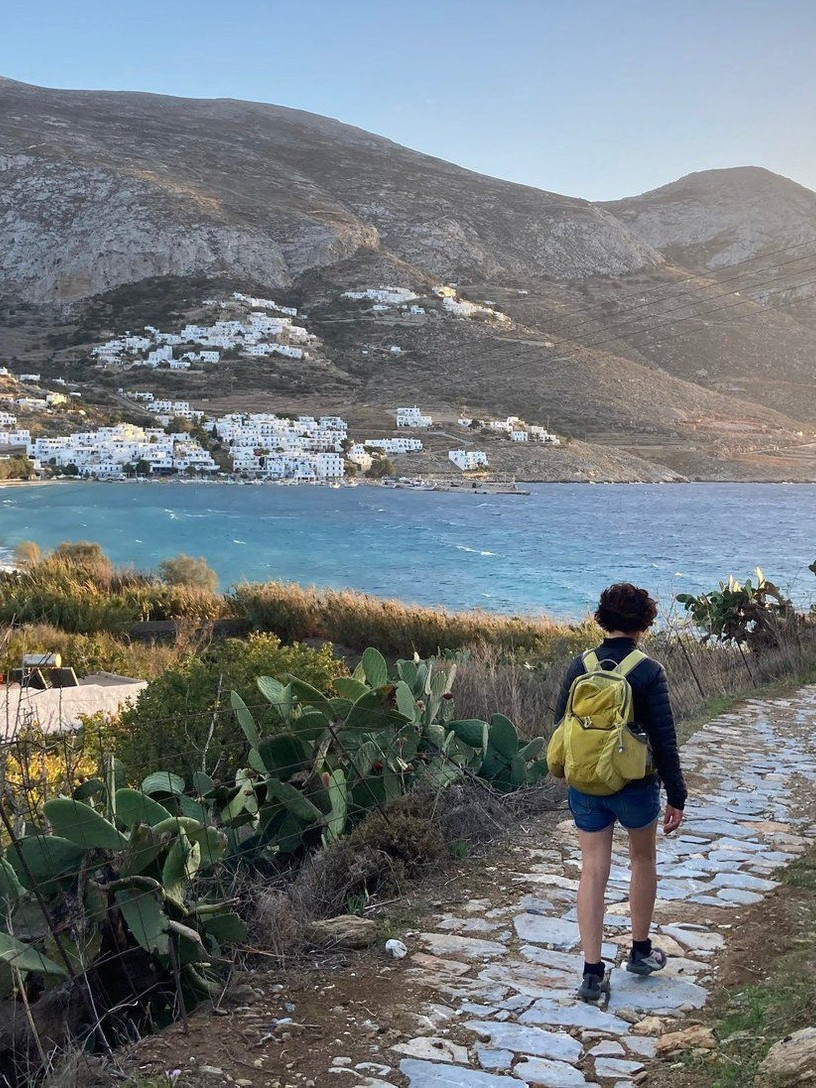© Wilfrid Valette A hiker on a paved path above the bay of Amorgos in the Cyclades