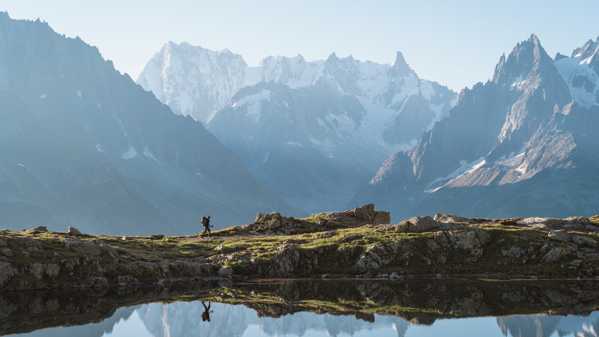 Hiker before the snow-capped peaks - Tour du Mont Blanc - France